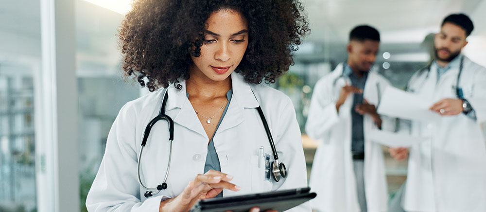 Female Physician Looking at a tablet for information about the 340b drug pricing program